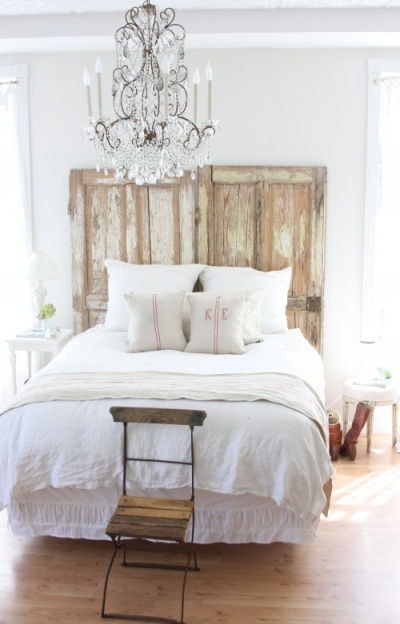 Rustic bedroom with repurposed reclaimed wood doors as a headboard