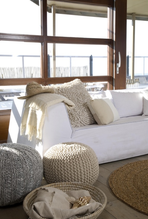 Poufs in a cozy coastal cottage living room