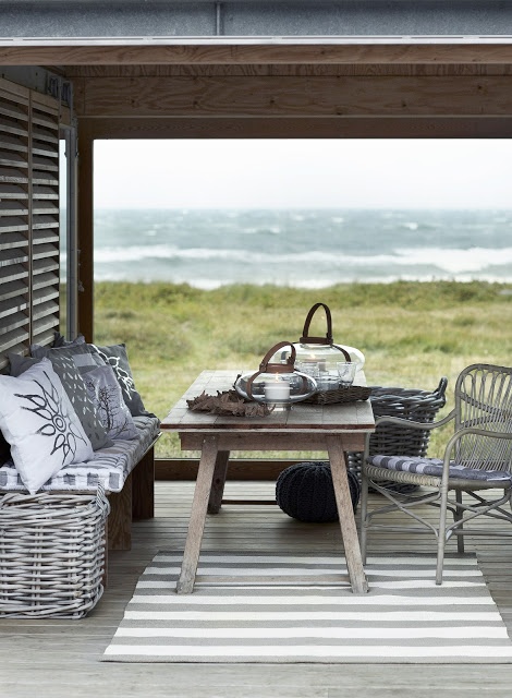 Coastal nook decorated in grey with a beautiful view of the ocean.
