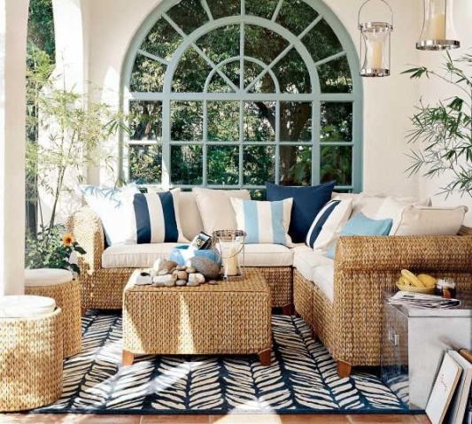 Coastal outdoor space with a cozy seating set up and a eclectic outdoor rug