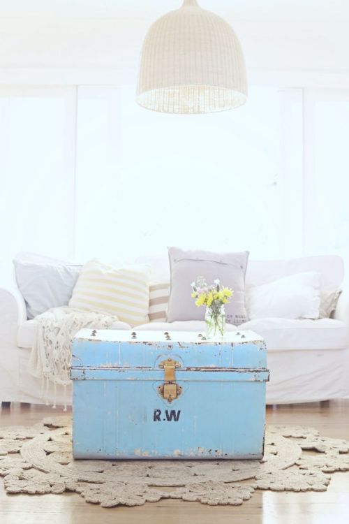 A vintage trunk doubles as a coffee table in a cute coastal living room