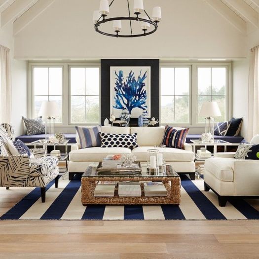 Coastal living room full of fun patterns with a blue and white color palette