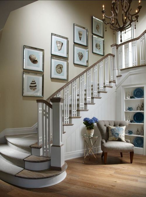 Gallery wall featuring shell art on a coastal stairway