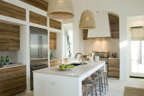 Modern coastal kitchen with natural wood accents and woven pendant lights