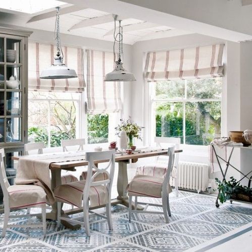 Open, naturally lit dining space with cozy, cottage feels and a geometric pattern on the floor