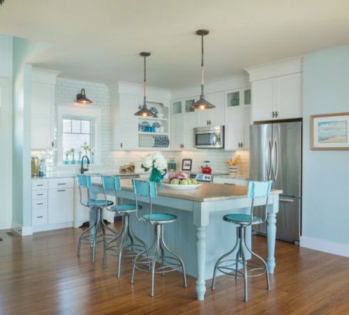 Coastal kitchen with a fun turquoise color palette and adjustable metal stools