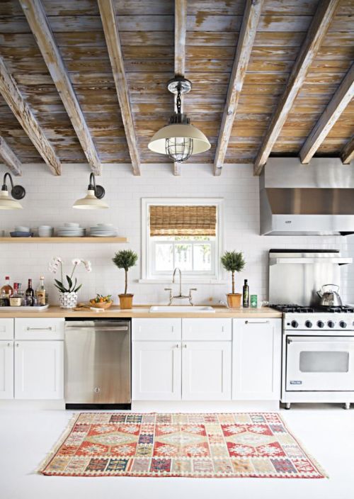 Coastal cottage style kitchen with minimal decor and a weather wood ceiling