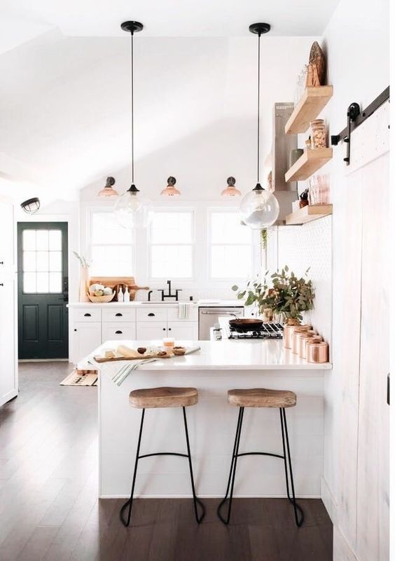 Coastal kitchen complete with wood topped stools and ball pendant lights
