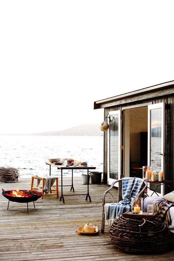 Simple coastal cottage patio right on the water