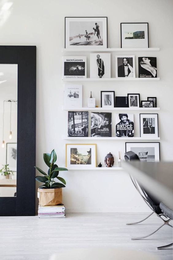 Black and white framed photos on a modern coastal wall